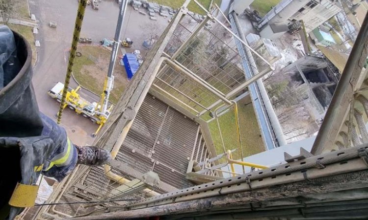 Installation d'un câble d'alimentation sur une grande tour d'un site industriel en Isère